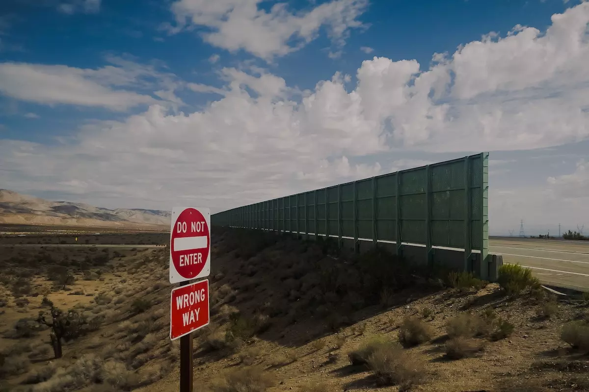 A road sign in the middle of a desert landscape