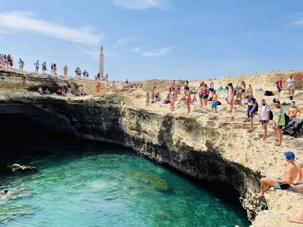 Tourists ready to jump into the Grotta della Poesia cove for a swim
